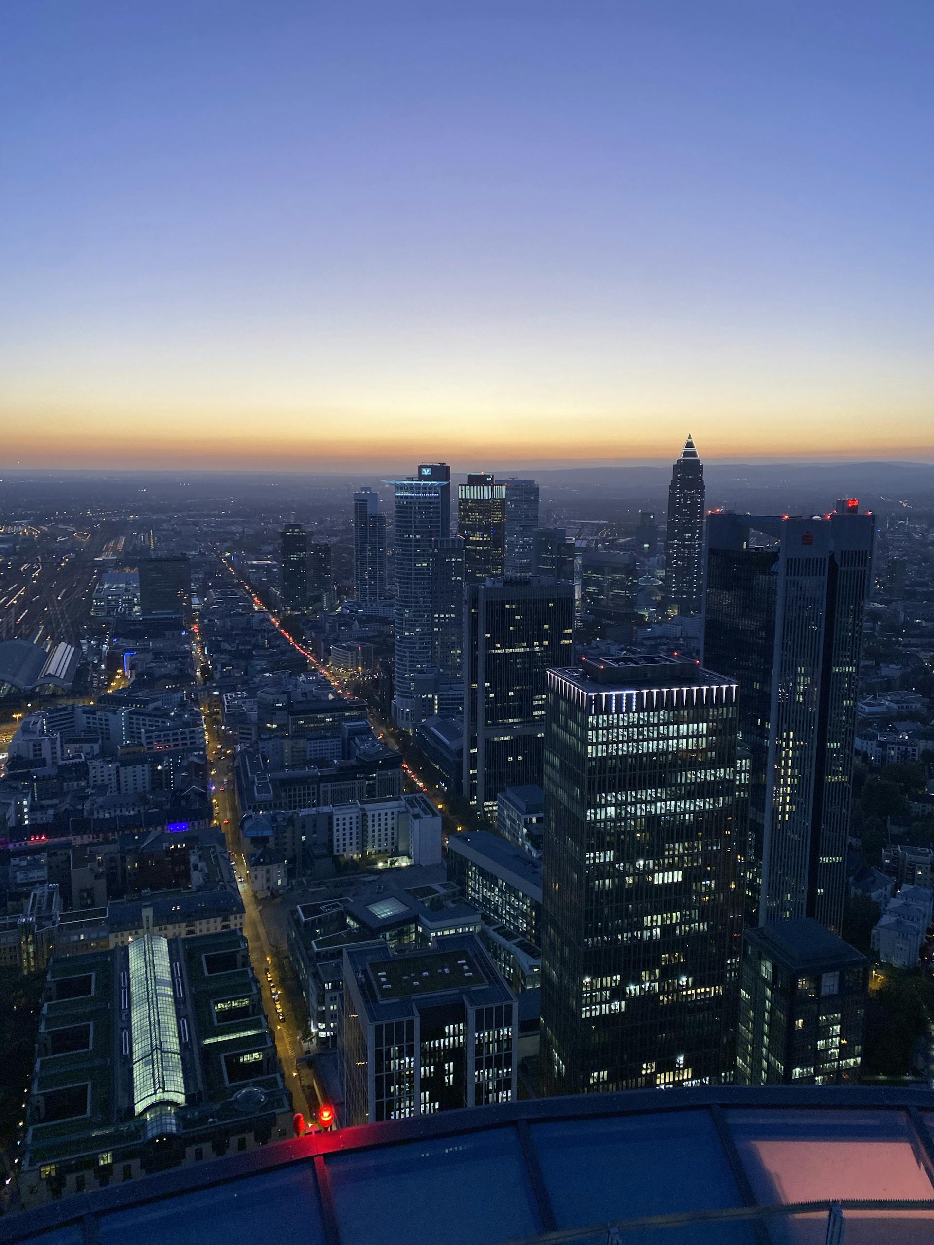 Stunning aerial view of Frankfurt's skyline at dusk showcasing illuminated skyscrapers.